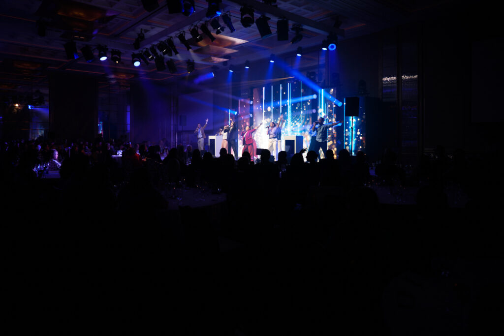 Stage with performers and spotlights
