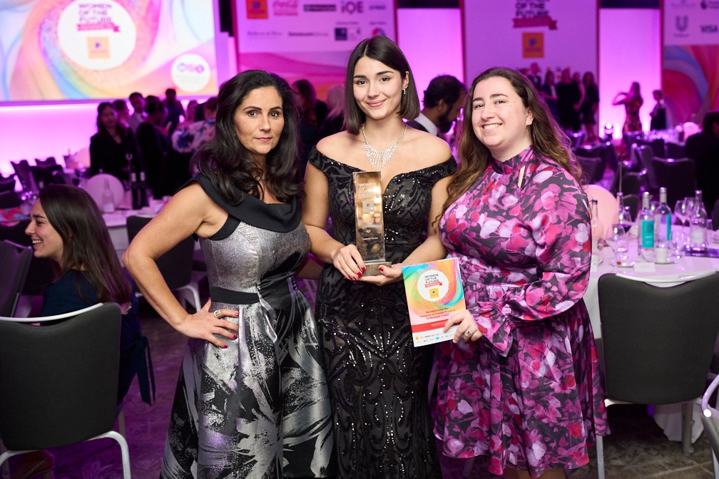 three women celebrate with their award