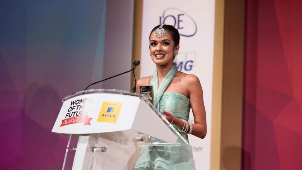 woman at lectern holding an award
