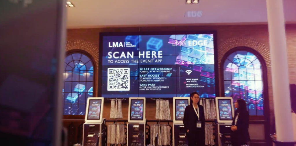 Touch screen badge printing kiosks to check into an event with lanyards hung up
