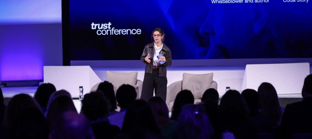 Female speaker on conference stage talking to audience